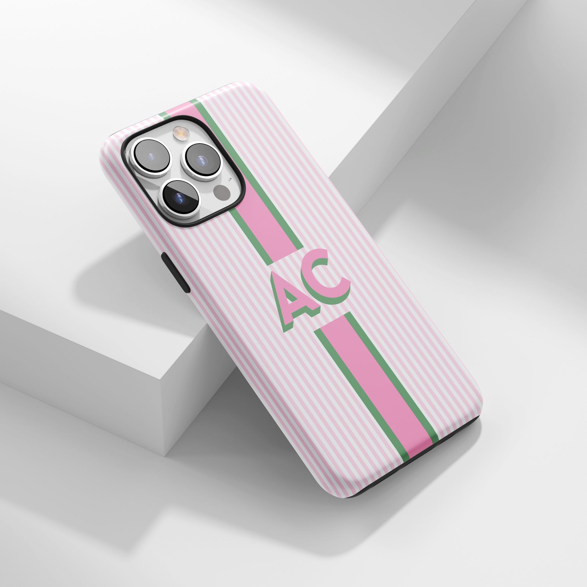 Pink and green striped phone case with bold AC initials.